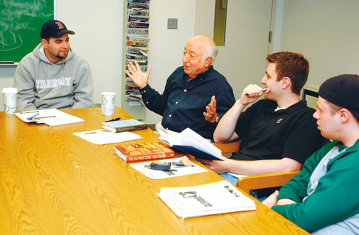 Ottaway professor talking with students at table